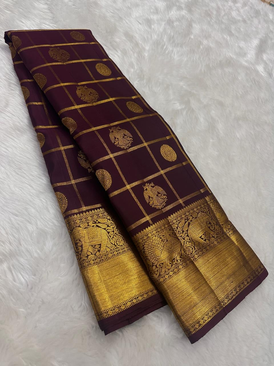 Deep aubergine Pure Silk Kanchipuram saree with gold Zari Kattam checks, handwoven Gandaberunda motifs and broad antique gold zari border.