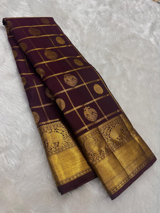 Deep aubergine Pure Silk Kanchipuram saree with gold Zari Kattam checks, handwoven Gandaberunda motifs and broad antique gold zari border.