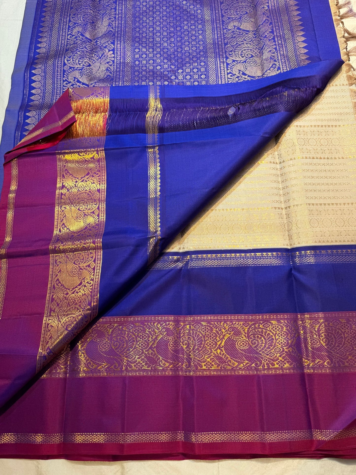 Purple grand pallu with gold zari peacock motifs on KanchiPattu silk saree