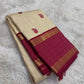 Gold beige KanchiPattu silk body close-up showing maroon silk thread paisley butta motifs
