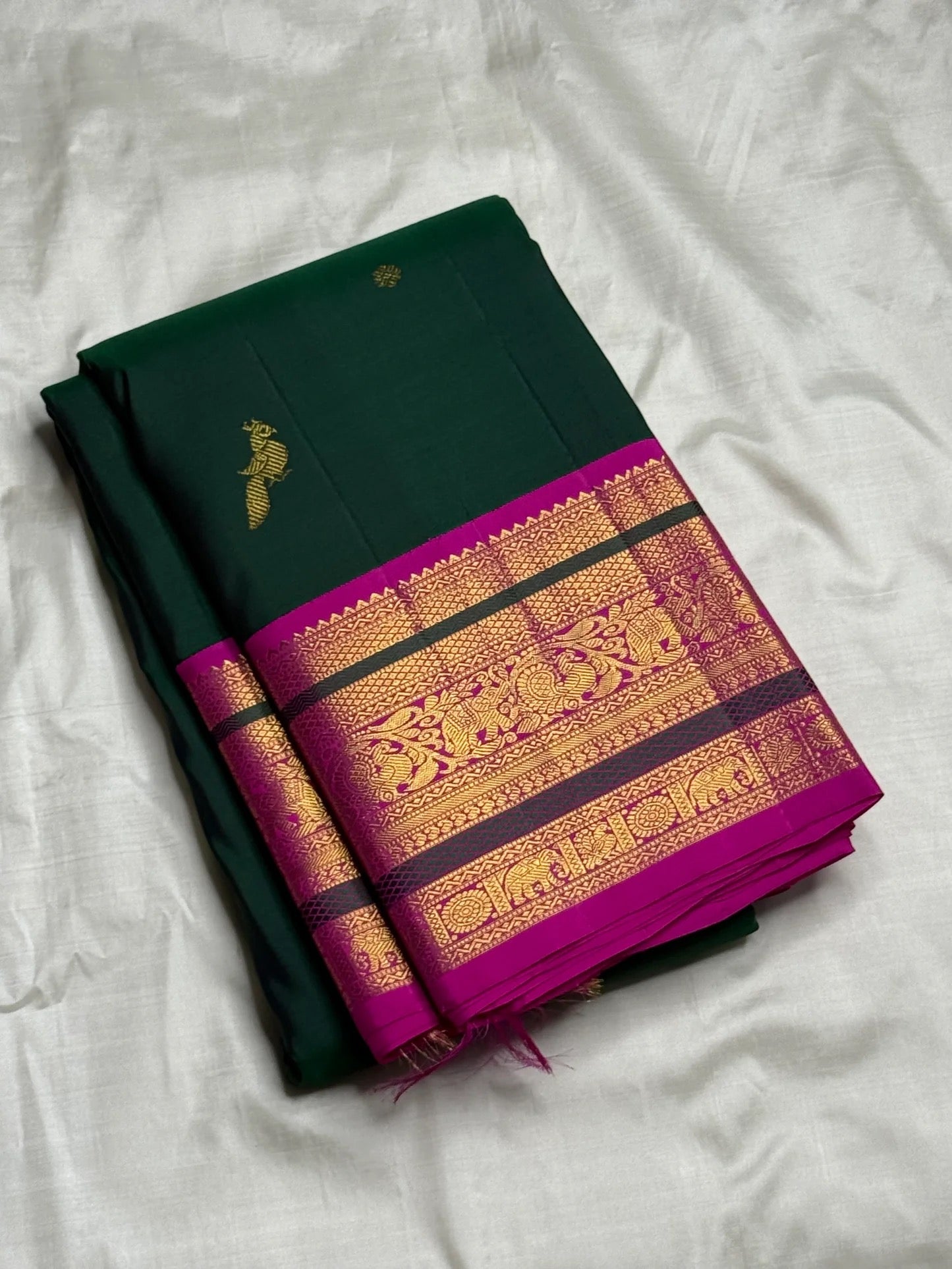 Magenta korvai border with gold zari vanasringaram animal panels on emerald green saree — Idam Living
