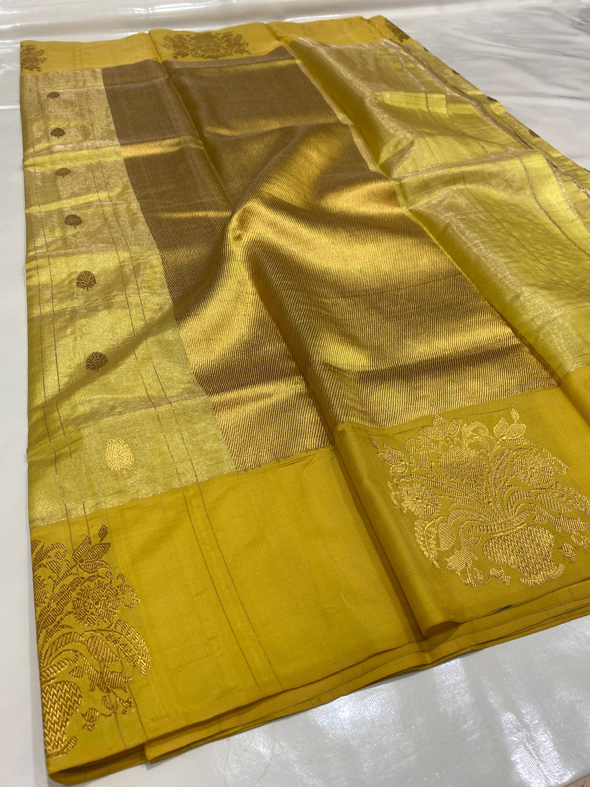 Turmeric Gold Chanderi saree border detail with large ornamental floral and foliage motifs on a mustard-gold ground