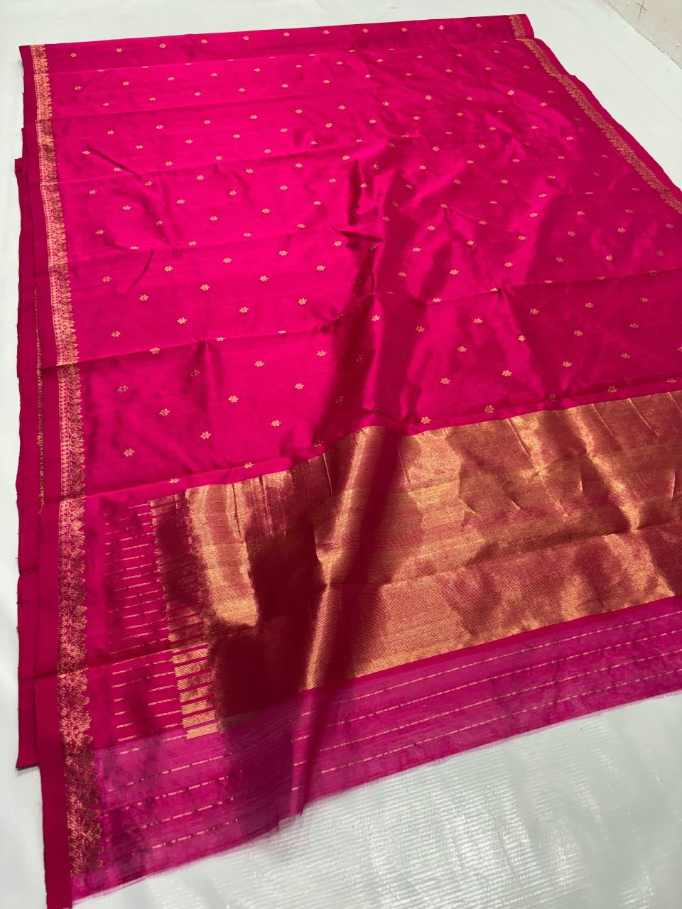 Small gold-toned floral motifs on pink Chanderi silk