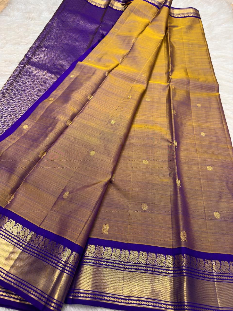 Gold Kanchipuram Korvai saree with royal violet zari border and Mayil Chakram buttas