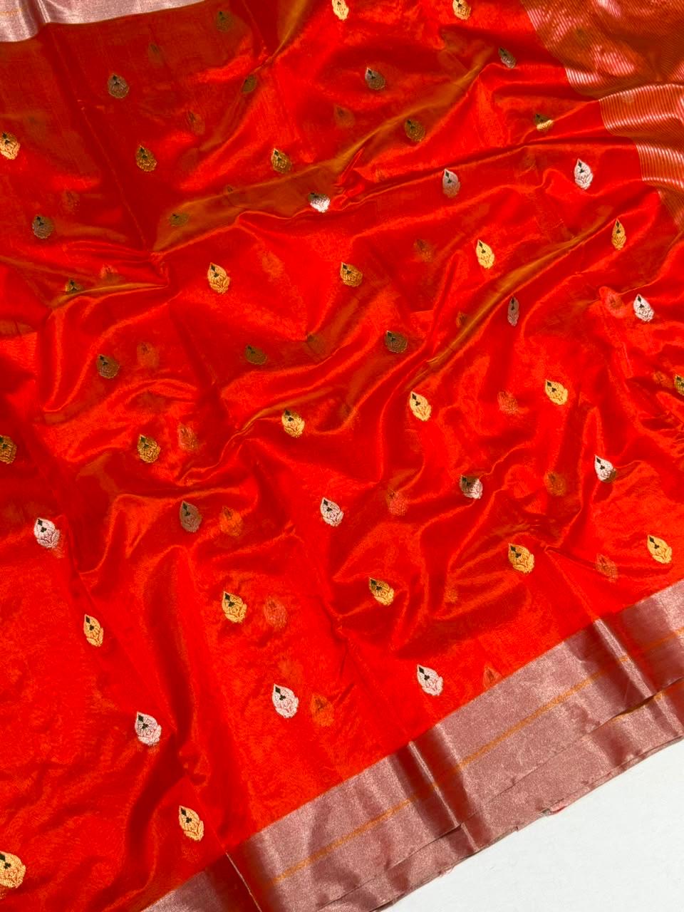 Gold and silver leaf-shaped buttas woven across a Vermilion Red Pattu Silk Chanderi saree