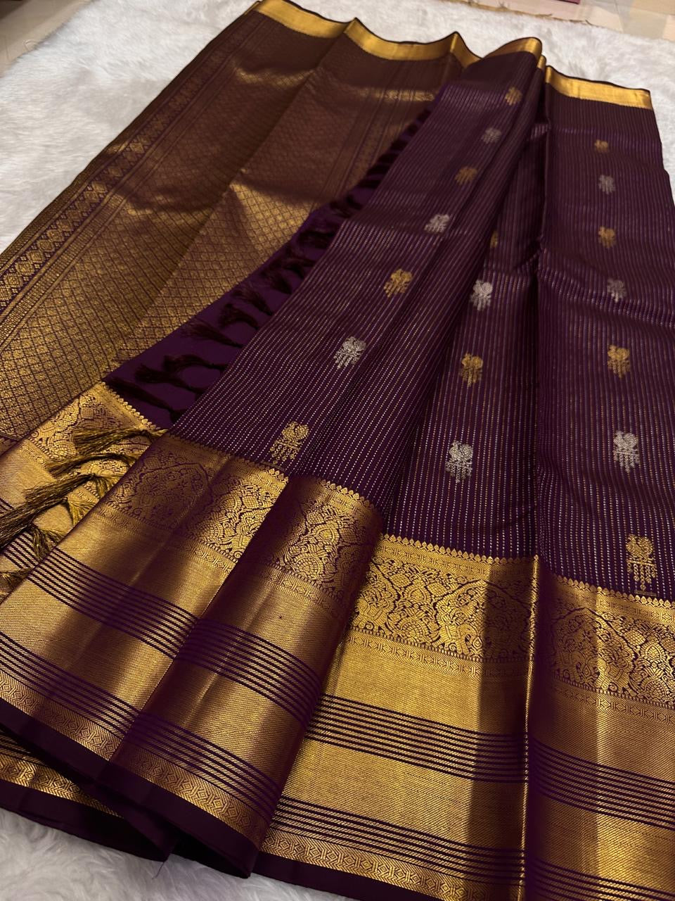 Gold and silver zari buttas scattered across the Kathiri Purple silk.