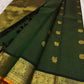 Close detail of bird-inspired gold zari buttas and round ornamental medallions within the fine checked body.