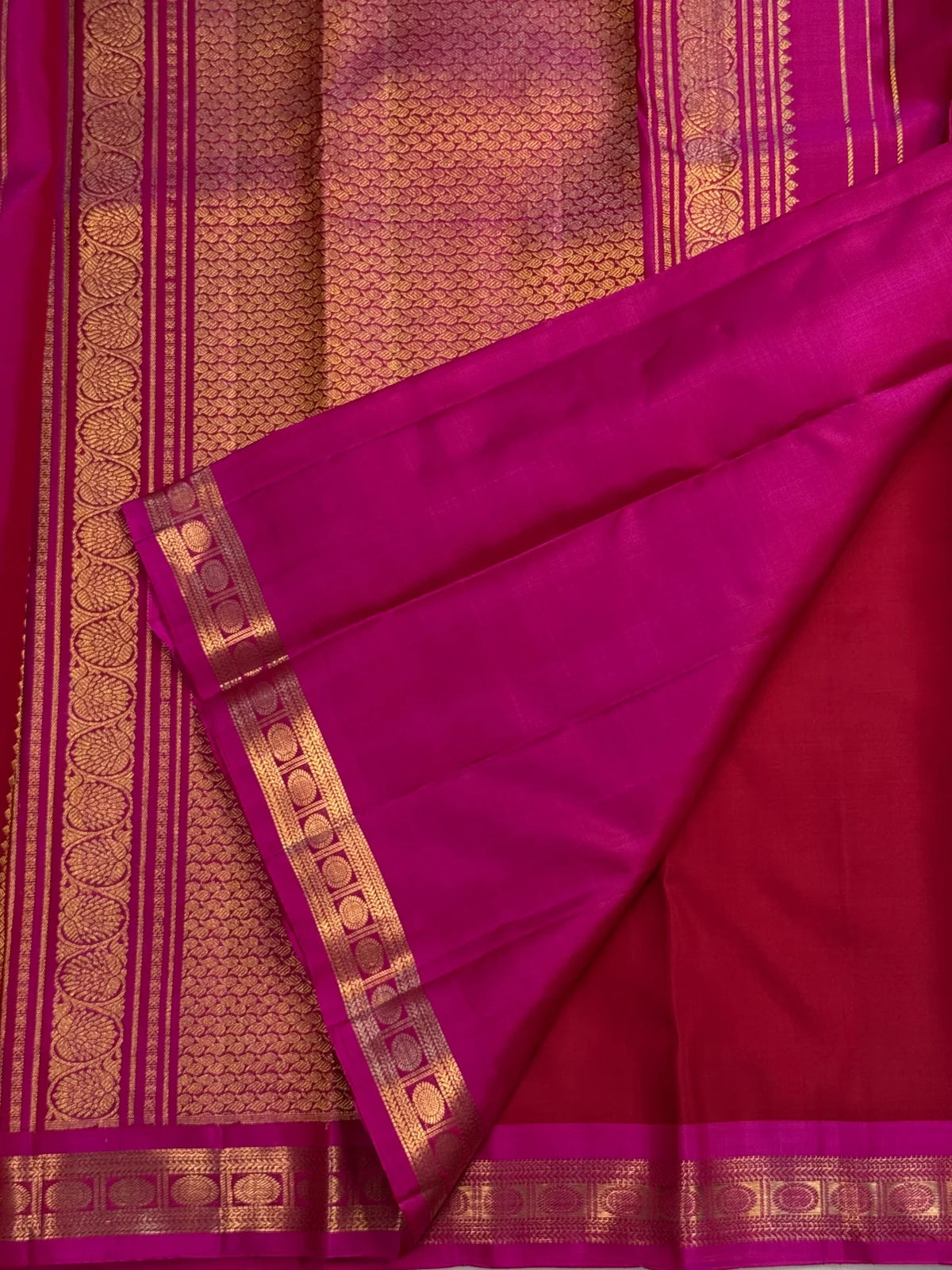 Detail of gold zari butta weave on deep crimson Kanchipuram silk saree
