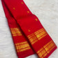 Gold zari buttas on the deep raspberry pink Kanjipuram Rettapet saree body