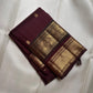 Close-up of gold zari buttas on Deep Plum Kancheepuram silk saree body