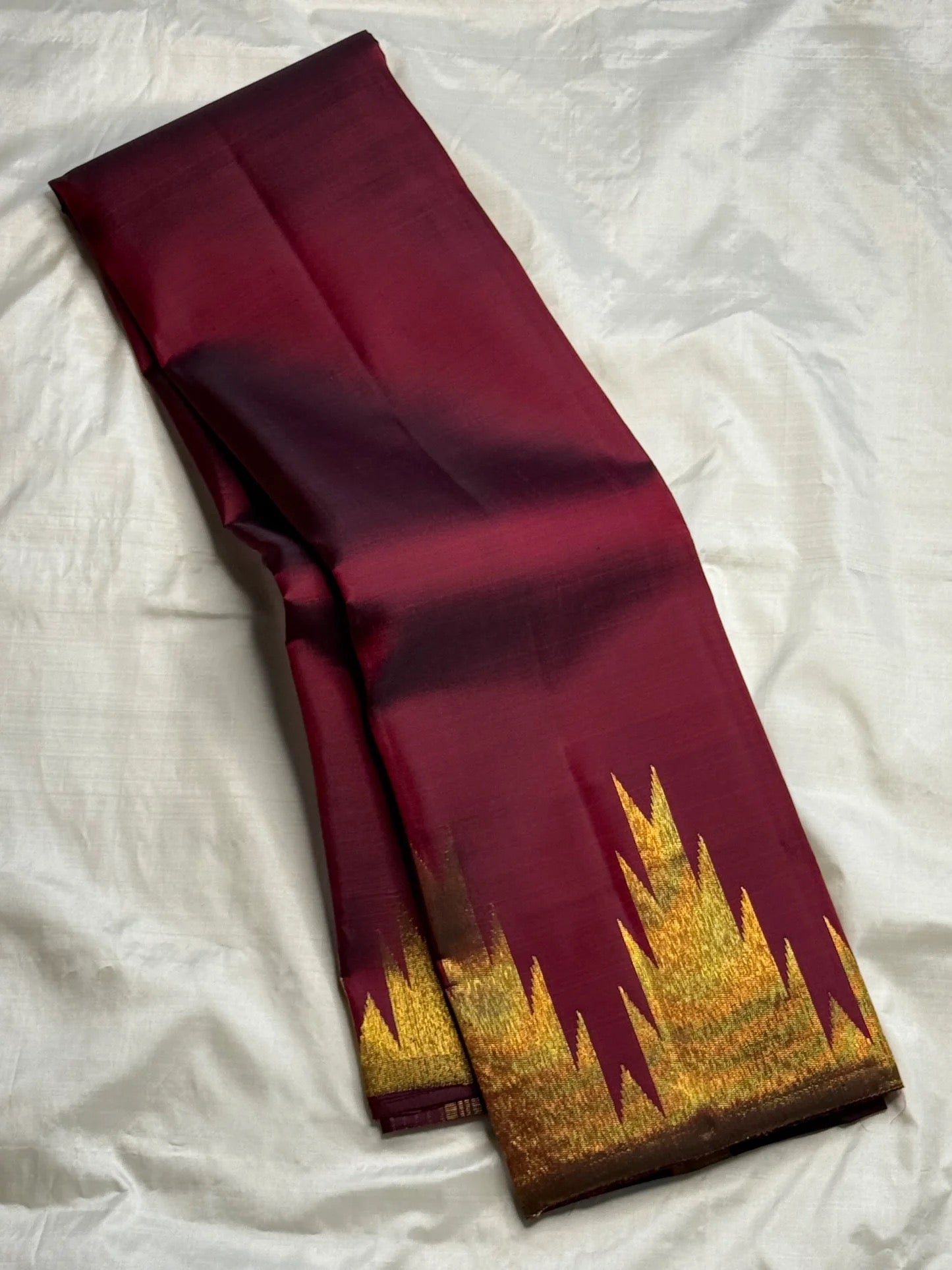 Gold zari Ettukol temple border detail on deep maroon Kanchipattu silk saree