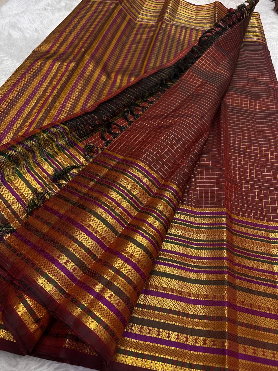 Gold zari lines on the deep cocoa maroon Kanchipuram Varisaipet saree body