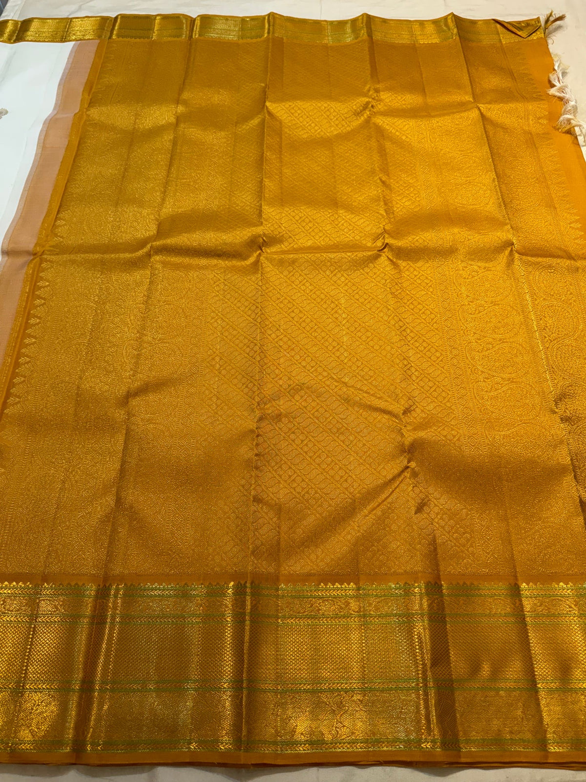 Handwoven ivory Kanjivaram saree with Mayil-inspired zari buttas