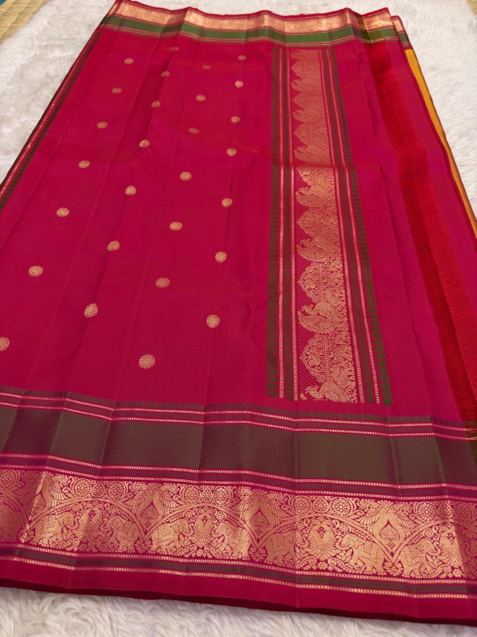 Broad magenta and olive-green border framed by gold zari bands and fine seer lines