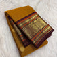Golden Mustard Kanchi Pattu Saree — body close-up showing gold zari buttas