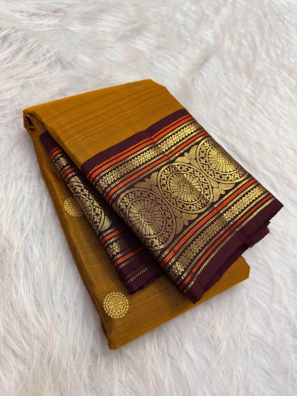 Golden Mustard Kanchi Pattu Saree — body close-up showing gold zari buttas