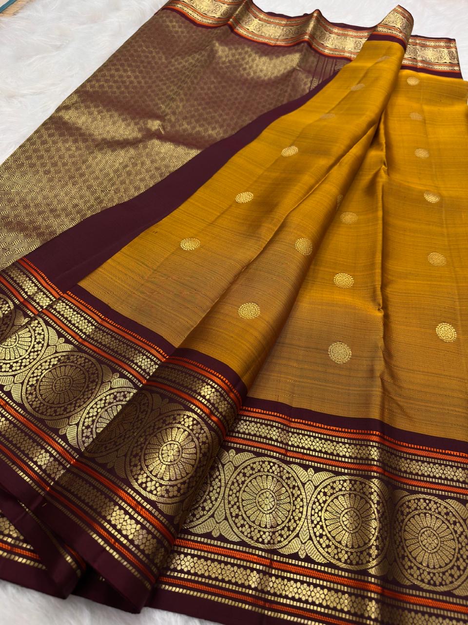 Golden Mustard Kanchi Pattu Saree — pallu detail with burnt-orange silk-thread accents