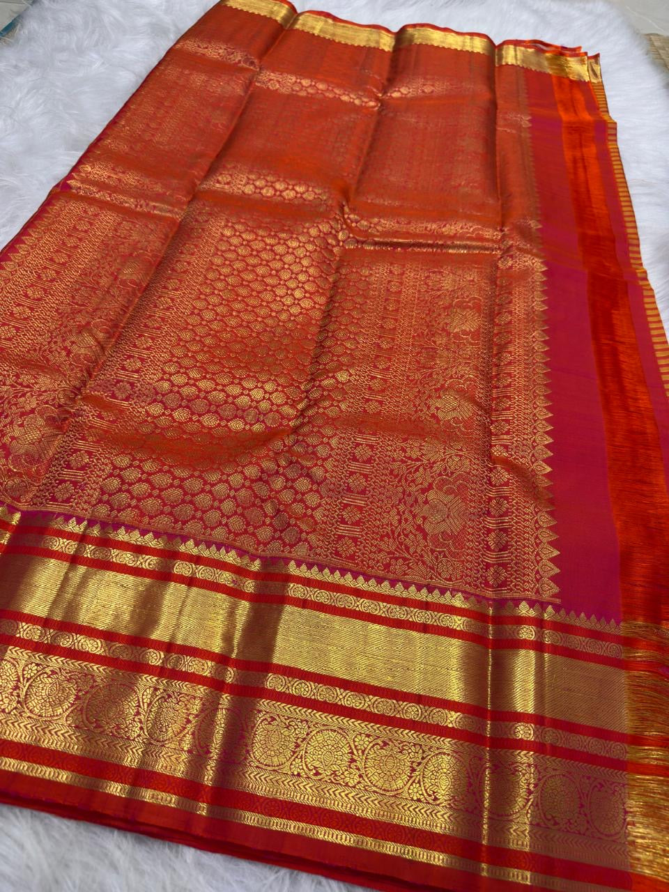 Handwoven Chen buttas spaced across the striped silk body of the golden mustard vermilion Vairaoosi saree.