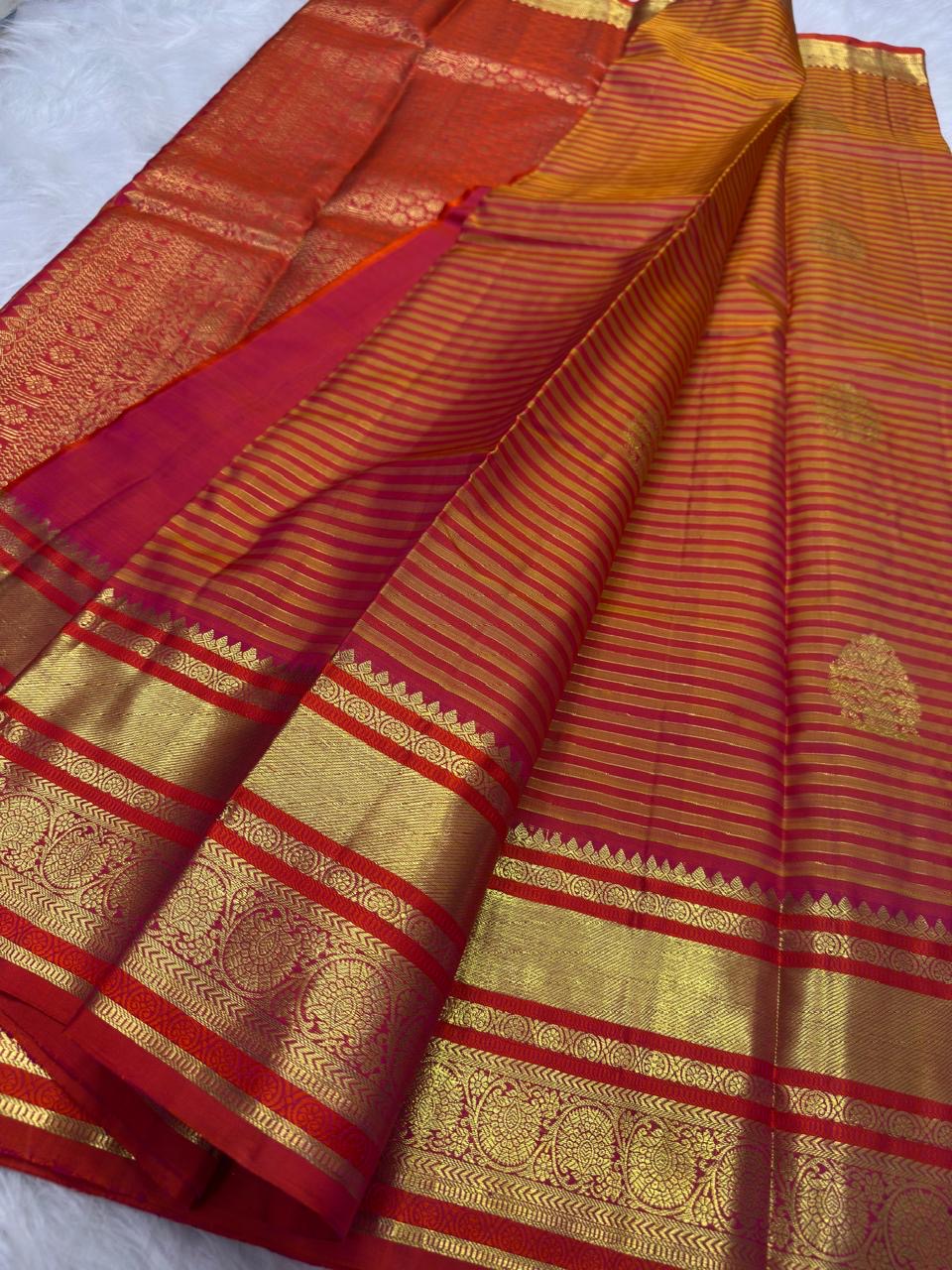 Close view of the golden mustard body with needle-fine Vairaoosi stripes and zari threads.