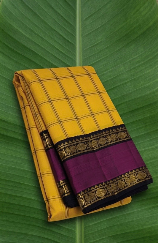 Golden mustard yellow Kanchipuram silk saree with orchid purple rettapet border and structured Kanchi Kattam checks