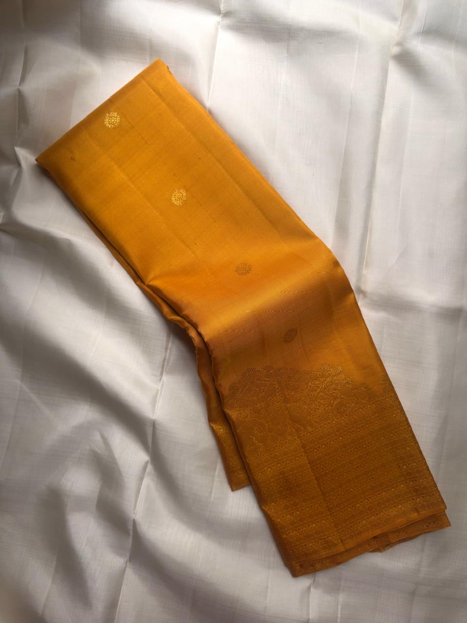 Golden turmeric Kancheepuram Butta silk saree — zari butta motif close-up