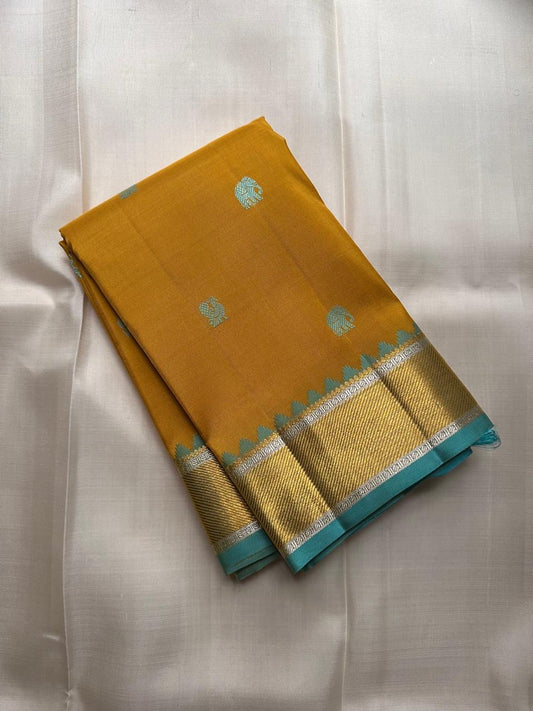 Golden Turmeric Kancheepuram silk saree pallu with deep zari work — Idam Living