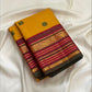 Close-up of yaanai (elephant) silk thread buttas on the golden turmeric Kanchipuram saree.
