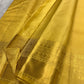 Close view of curved gold zari buttas woven across the Butter Yellow silk body