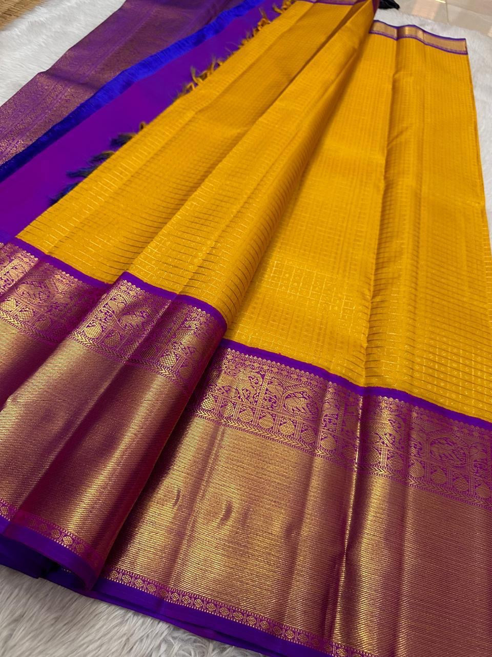 Golden Turmeric Yellow Kancheepuram Saree — royal-purple Korvai border with gold zari elephant motifs