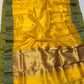 Crimson and gold decorative motifs on green saree border