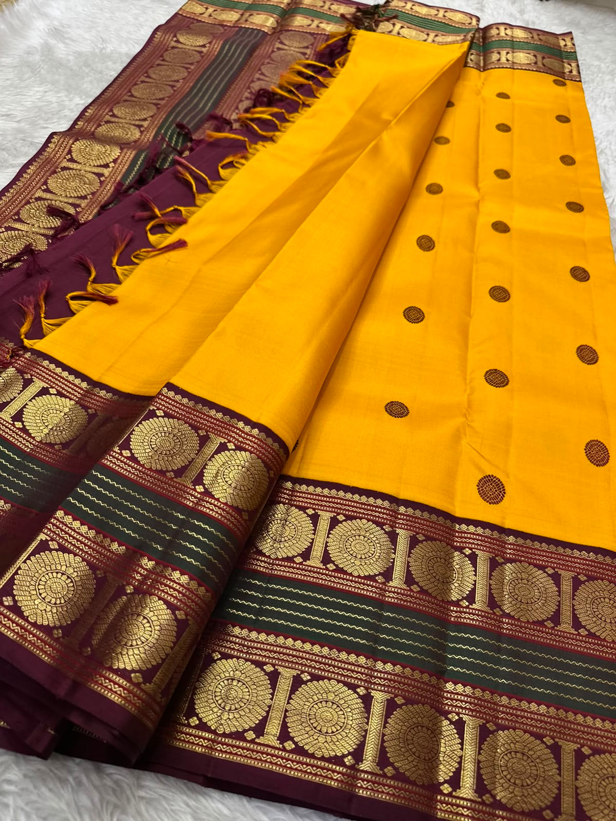 Golden yellow handwoven pure silk Kanjipuram saree with deep maroon Korvai border