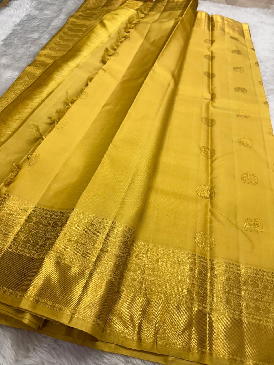 Folded Butter Yellow Varisaipet saree with woven gold buttas and ornate zari border