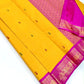 Golden-yellow Korvai saree showing petal-pink and deep-green Ganga Jamuna borders