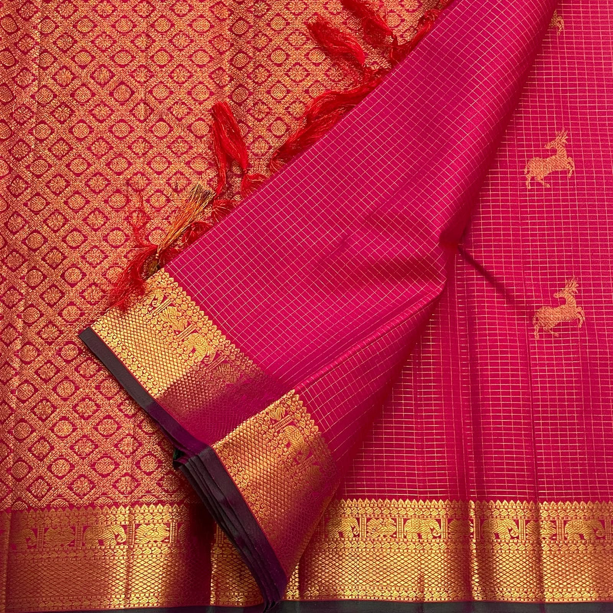 Grand array pallu in rich gold zari on a deep pink vintage Kanchipuram silk saree