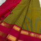 Turmeric yellow Kanchipuram silk saree with vetrilai green pattani kattam checks and brick red rettapet border folded flatlay Idam Living