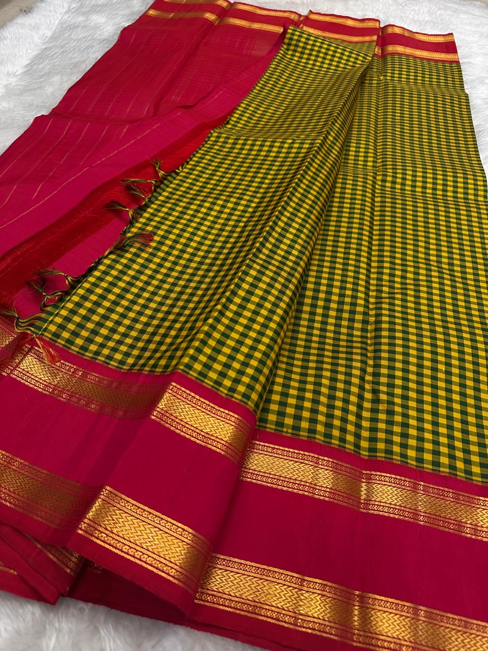 Turmeric yellow Kanchipuram silk saree with vetrilai green pattani kattam checks and brick red rettapet border folded flatlay Idam Living