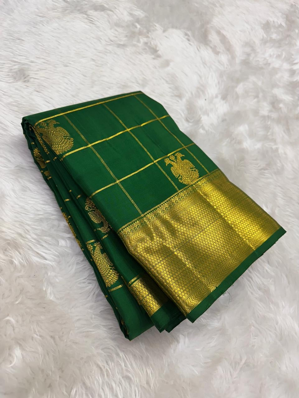Deep Emerald Green Gandaberunda Zari Kattam Kanjivaram saree with antique gold detailing, styled shot.