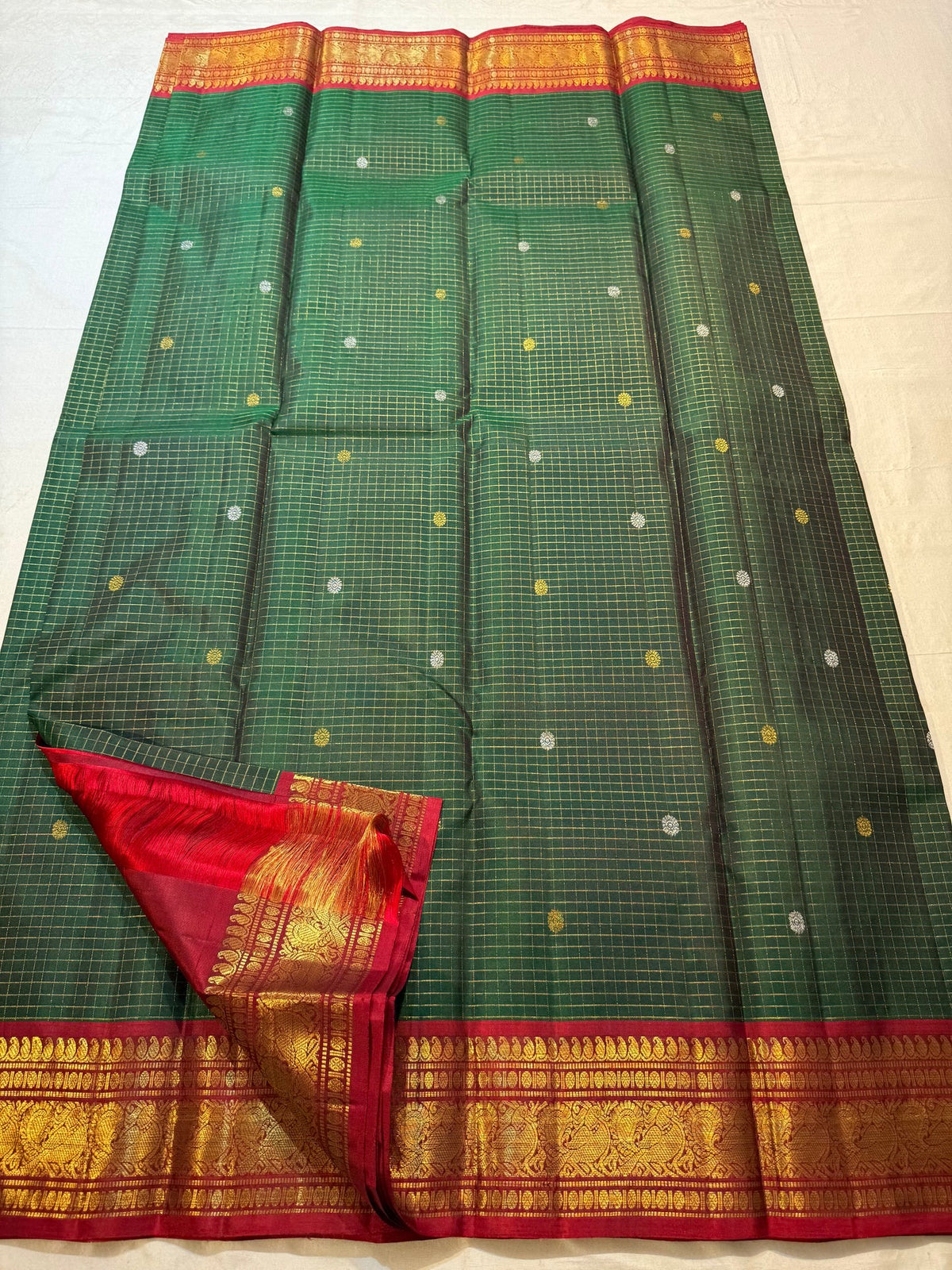 Handwoven Zari Kattam saree with Arakku Red border and antique-gold traditional weaving.
