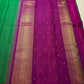 Close-up of Kamalam Butta gold-zari motifs on green Kancheepuram silk body