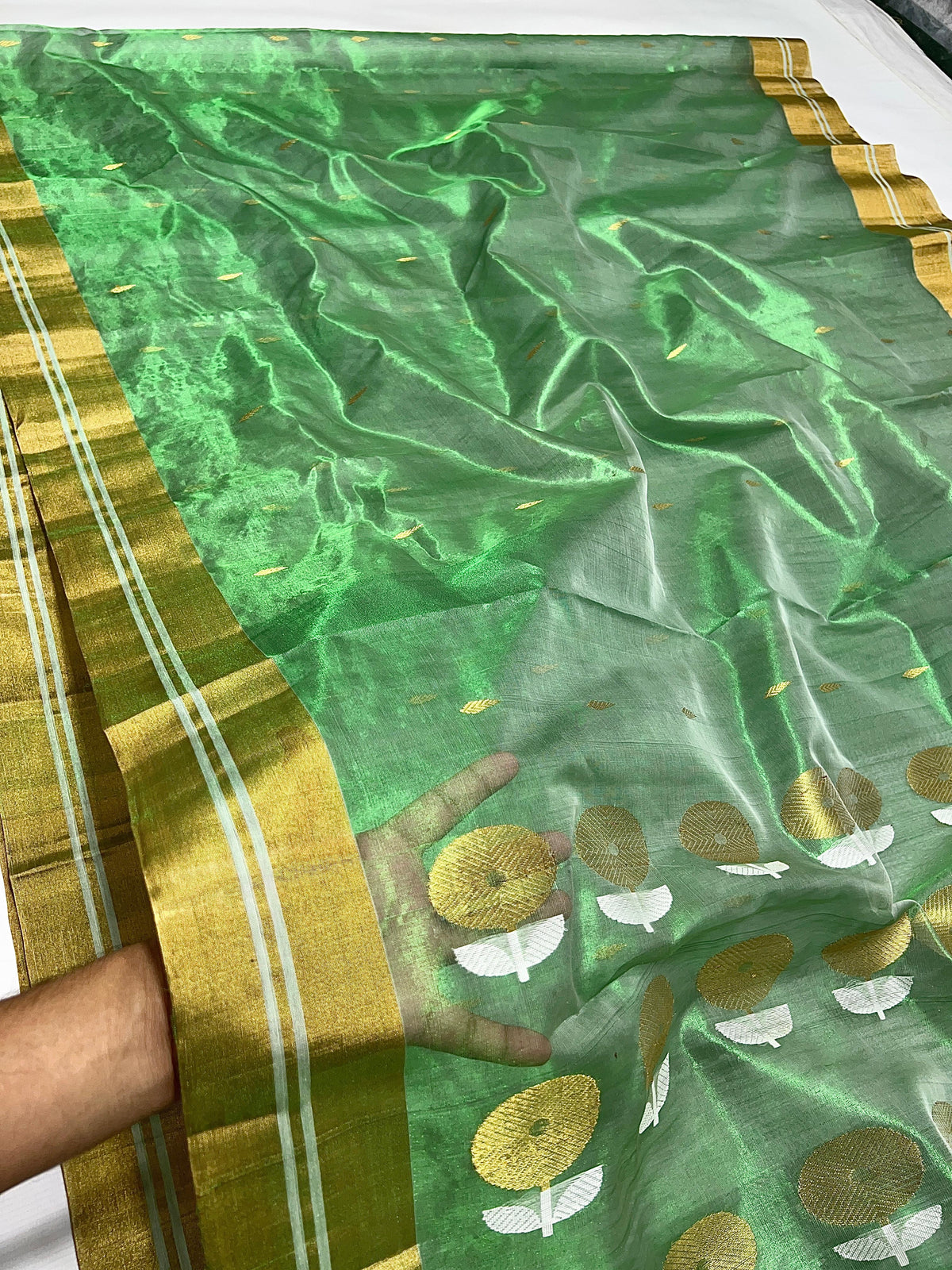 Circular gold and silver-toned motifs on green Chanderi saree