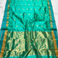 Turquoise Green Chanderi saree with gold bird motifs woven across a jewel-toned green field