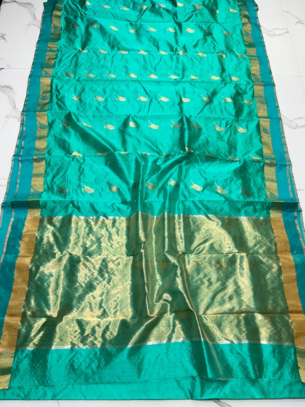 Turquoise Green Chanderi saree with gold bird motifs woven across a jewel-toned green field