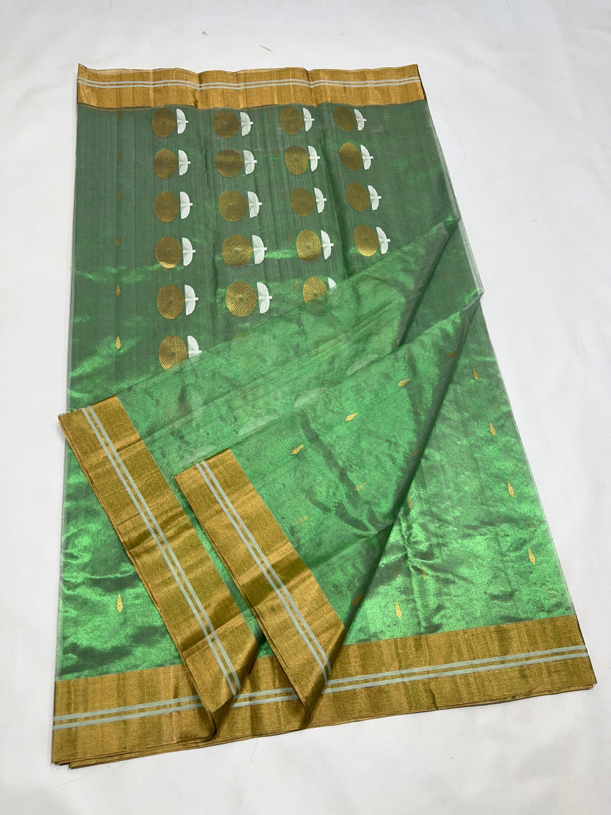 Close-up of gold zari border on green Chanderi saree