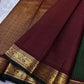 Close-up of maroon pallu with fine lines and gold zari woven elephant border