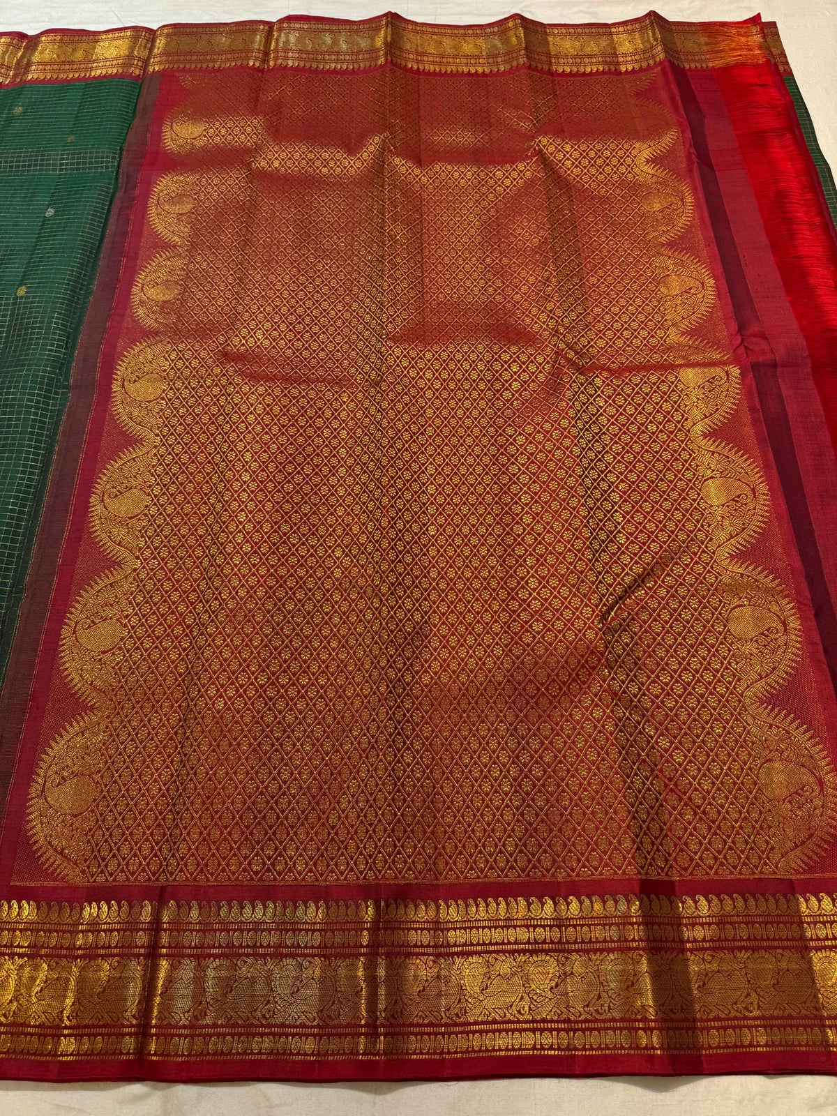 Deep Forest Green silk with gold and silver-toned zari buttas within the Kattam grid.