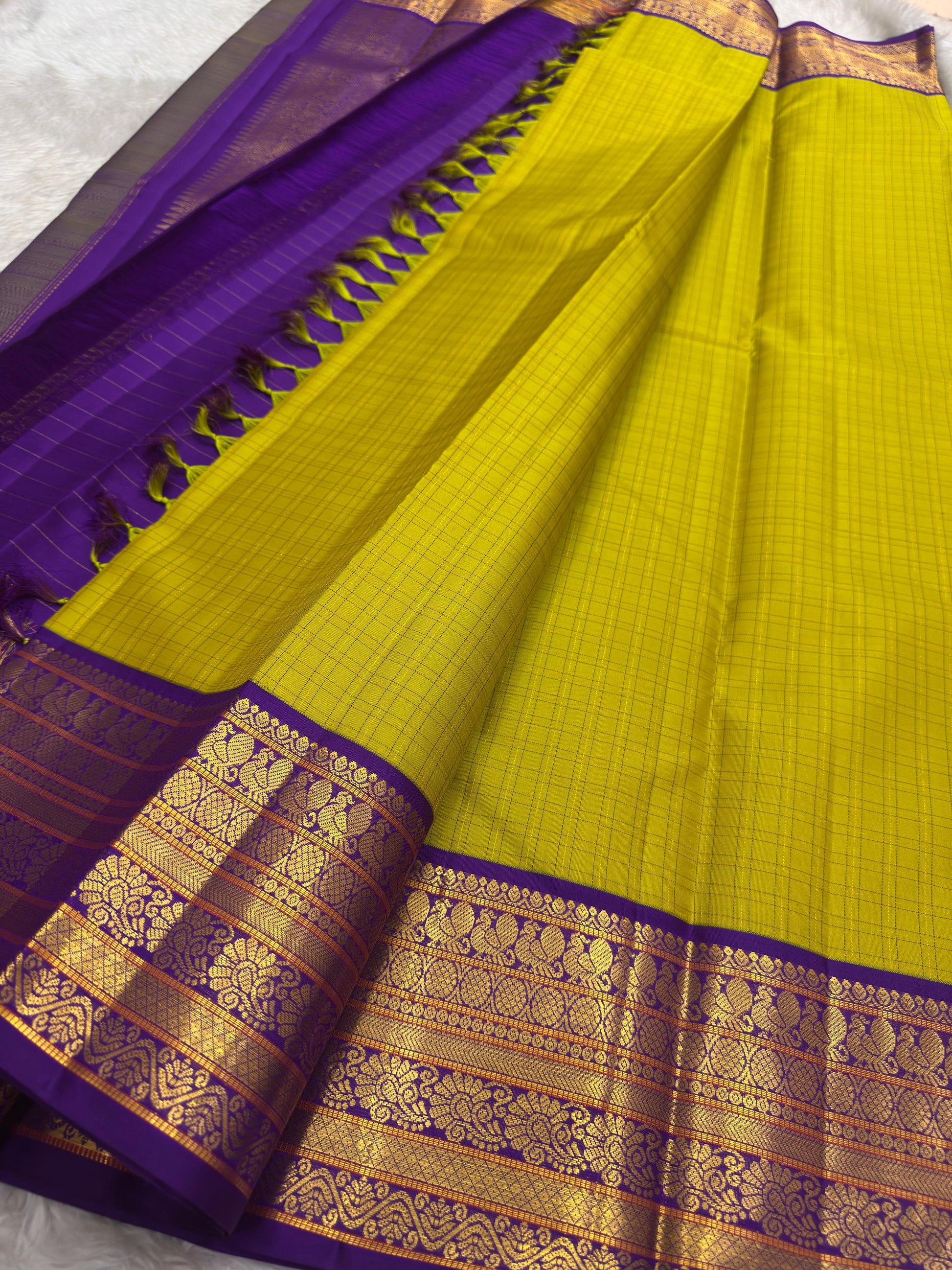 Traditional Kanchipuram silk saree showcasing Annapakshi motifs woven in antique gold zari