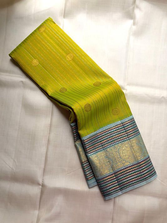 Green Kanjivaram silk saree with aqua contrast zari border and woven motifs