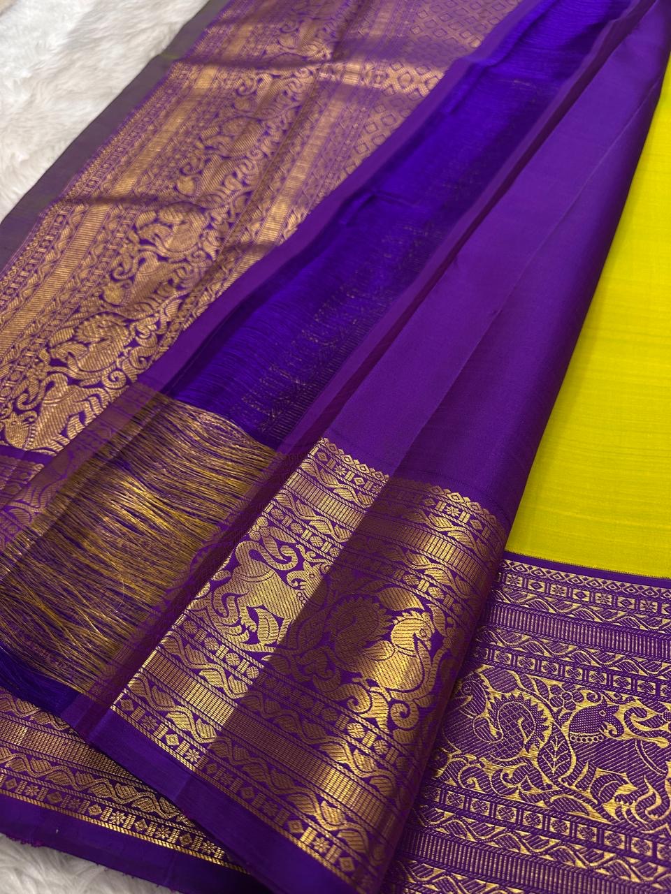 Green Kanchipuram saree with deep purple Annam motif border
