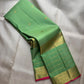 Fresh parrot-green Kanchipuram silk body with a fine classic-gold Zari Kattam grid and open silk field.