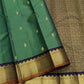 Emerald green Pure Silk Kanjipuram saree with spaced gold zari buttas and a deep navy gold zari border.